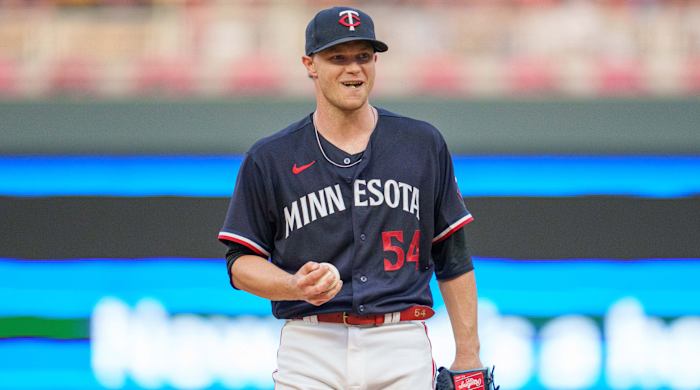 Minnesota Twins starting pitcher Sonny Gray holds the ball while smiling against the Chicago White Sox.